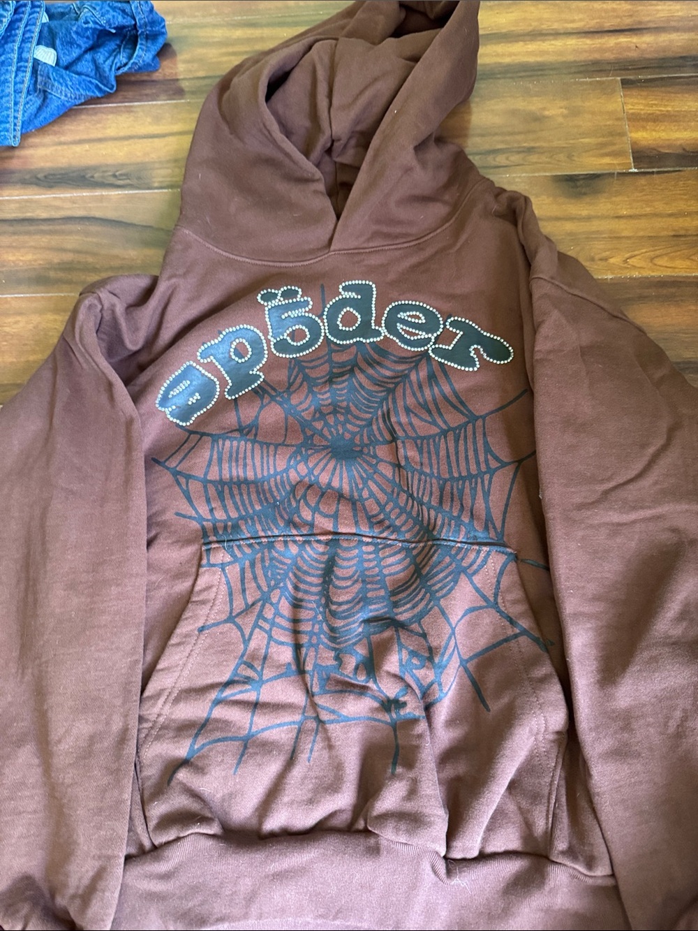 Stüssy Brown Zip-Up Hoodie with Black Spider Web Graphic